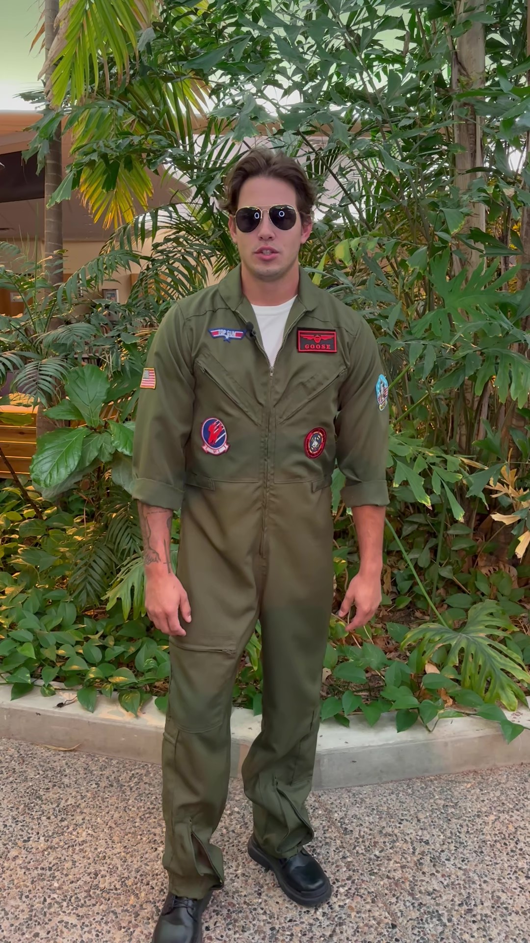 Take your Halloween look to new heights with this exclusive Men's Top Gun Premium Flight Suit Costume! Slip into this iconic outfit and feel like you're soaring on cloud 9.